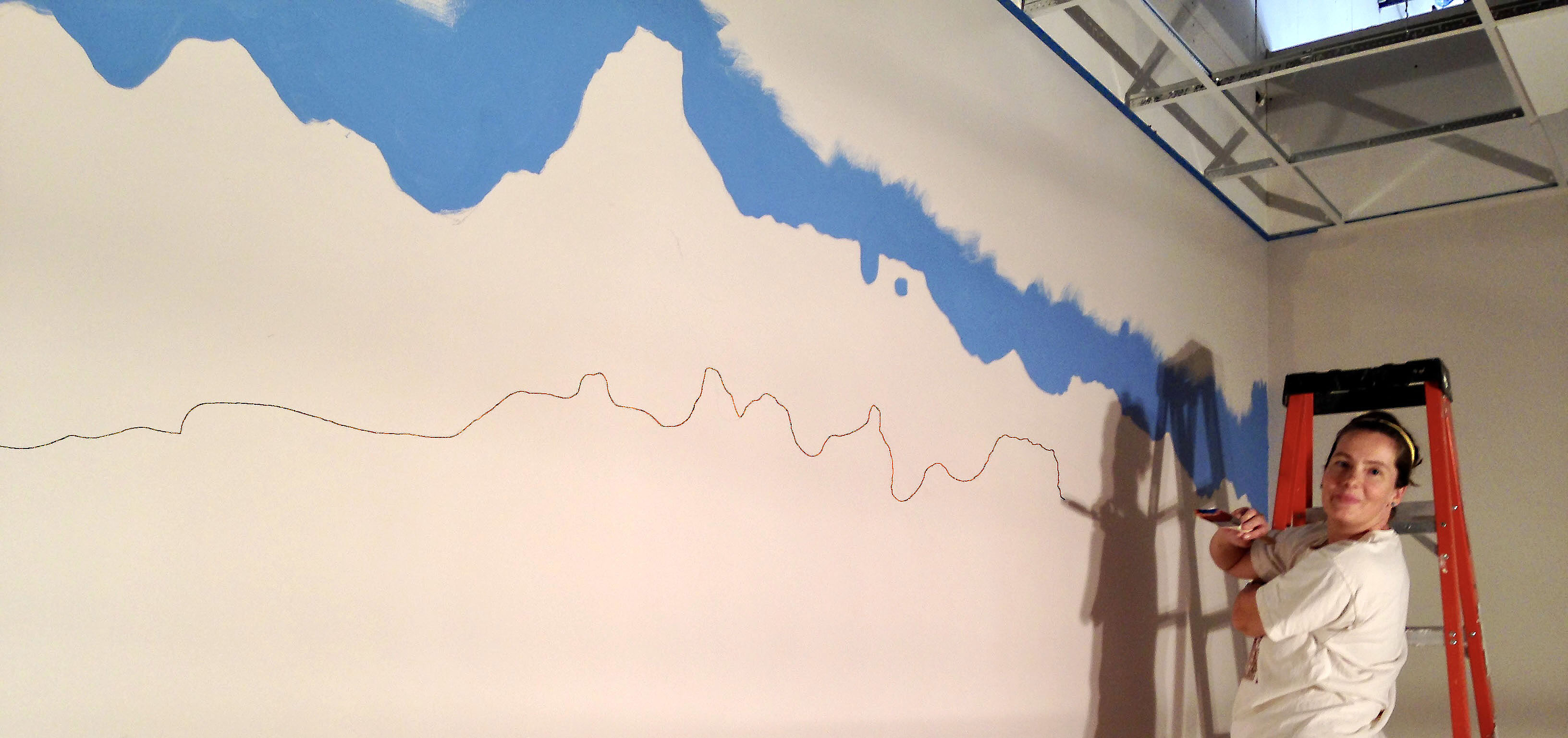 Chris Venema painting a mural